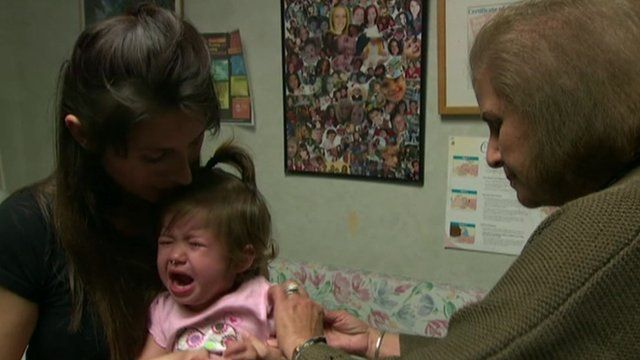 A crying baby having her vaccination