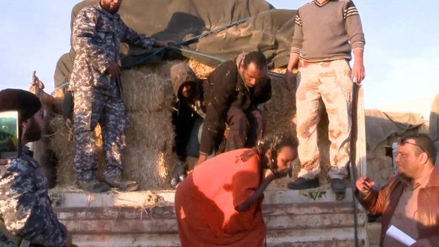 Migrants emerging from truck