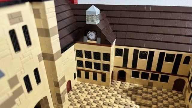 A close up of the beige Lego bricks making up the inside of the Ightham Mote replica with black and clear bricks visible marking windows and doors