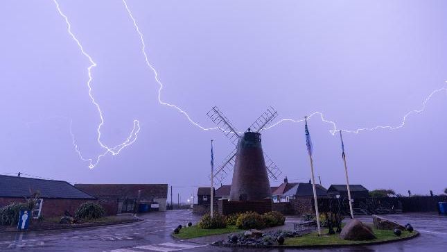 Lightning strikes near a windmill in Selsey, West Sussex