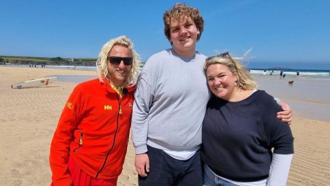 Three people on a beach