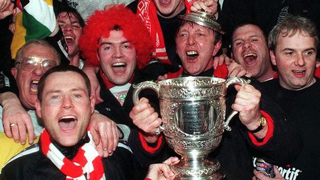 Marty Quinn celebrates with Cliftonville fans