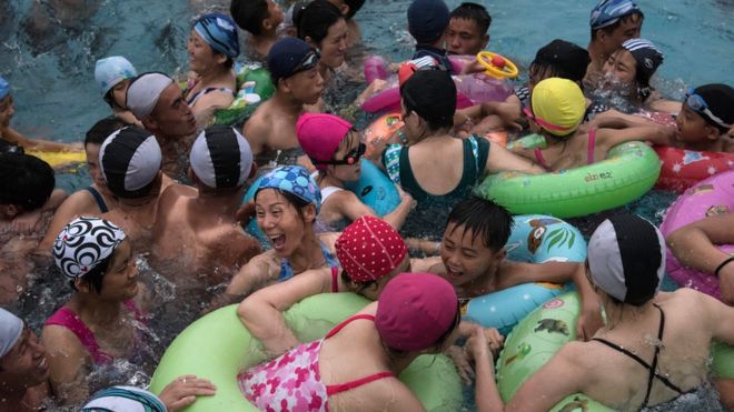 Swimmers gather in a wave pool at a water park in a leisure complex in Pyongyang on July 21, 2017
