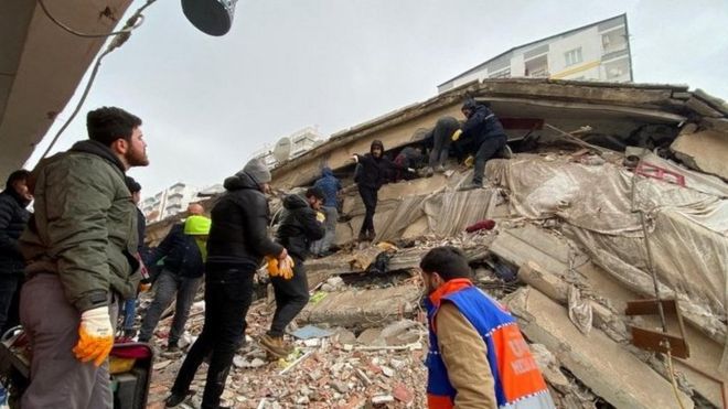 emergency services and civilians helping at quake site