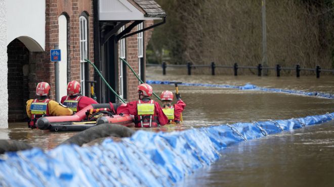 Personnel from the Severn Area Rescue Association (SARA) wade through flood water in Bewdley to check on the welfare of residents after the River Severn breached defences on 23 February 2022 in Bewdley, Worcestershire