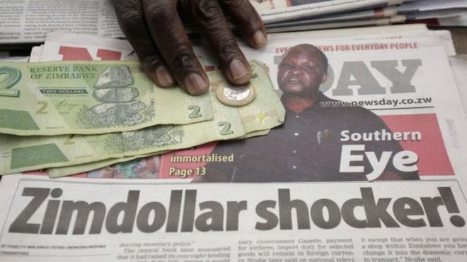 A headline of a local newspaper on the ban of the foreign currency is displayed on a street in Harare, Zimbabwe, 25 June 2019