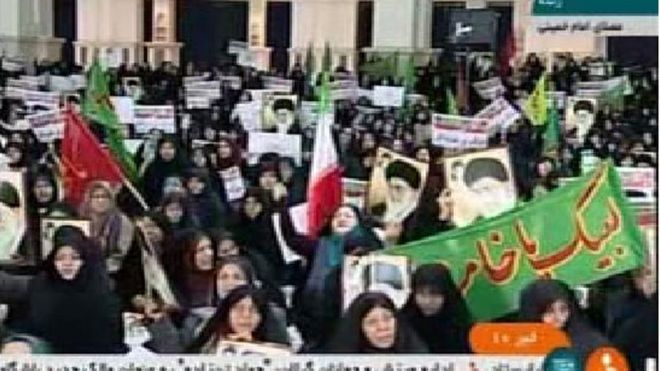 crowds carrying flags