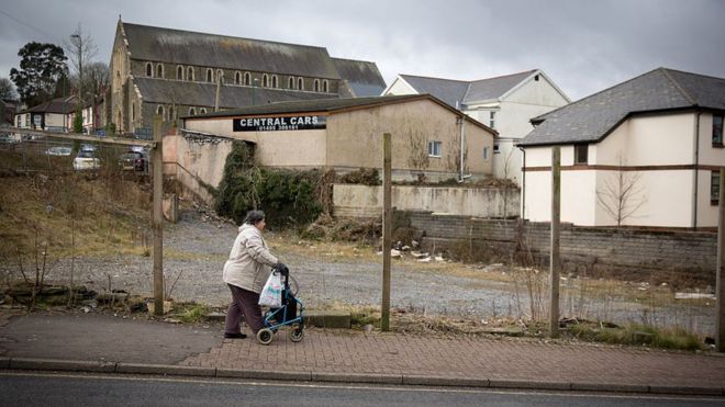 Женщина проходит мимо заброшенного места в Эббв-Вейл в Блейнау-Гвинт, Уэльс