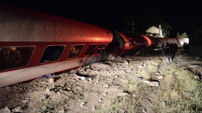 Firefighters at the scene of a derailed train near the village of Adendro, some 40km (25 miles) west of Thessaloniki, Northern Greece, 14 May 2017