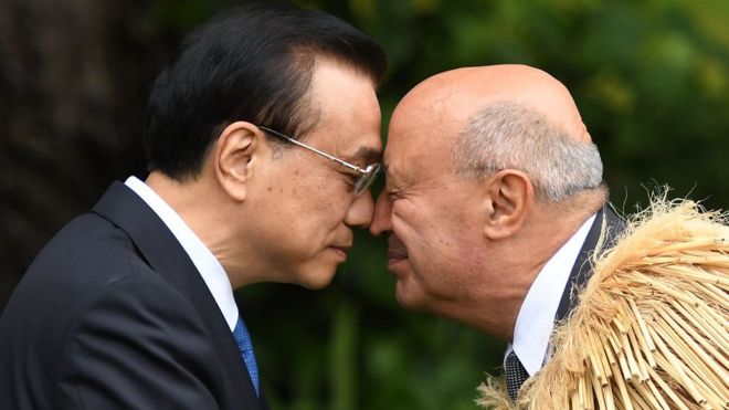 China's Premier Li Keqiang (L) is welcomed to Government House by a Maori elder during a welcome ceremony in Wellington on March 27, 2017.