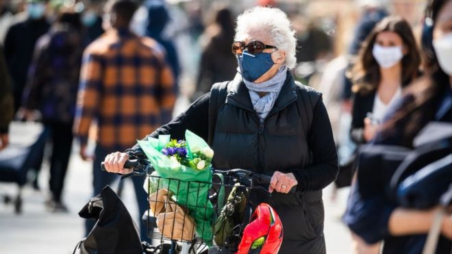 A person wears a face mask while shopping at the Union Square Greenmarket