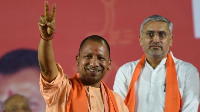 Chief Minister of India's Uttar Pradesh Yogi Adityanath (L) gestures during a Bhartiya Janta Party (BJP) rally ahead of India's general election, in Ahmedabad on March 26, 2019.