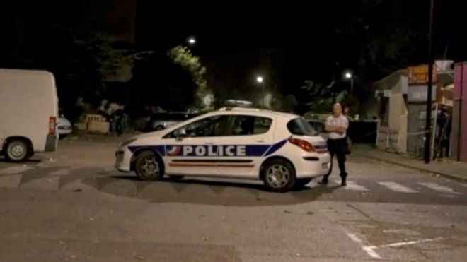 A police officer stands guard on a street near the scene of a shooting in front of a mosque, 2 July 2017