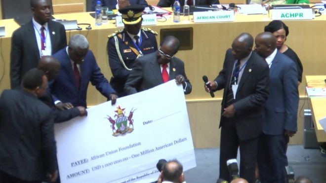 President Mugabe with the cheque