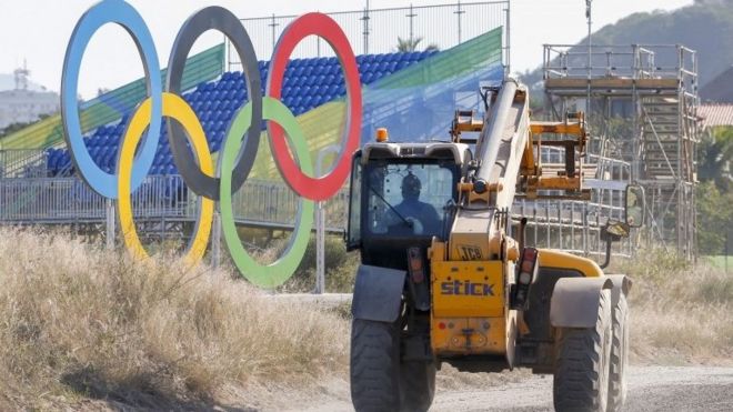 A construction vehicle passes the Olympic Rings near the sixteenth green at the Olympic Golf Course in Barra da Tijuca, Rio de Janeiro, Brazil, 01 August 2016.