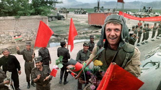 A Red Army soldier atop of his armoured personal vehicle smiles 16 May 1988 as Soviet Army troops stop in Kabul prior to their withdrawal from Afghanistan. The Soviet war in Afghanistan, also known as the Soviet-Afghan War, was a nine-year conflict involving Soviet forces supporting the Marxist People's Democratic Party of Afghanistan (PDPA) government against the Mujahideen resistance. The initial Soviet deployment of the 40th Army in Afghanistan began on August 7, 1978. The final troop withdrawal began on May 15, 1988, and ended on February 15, 1989.