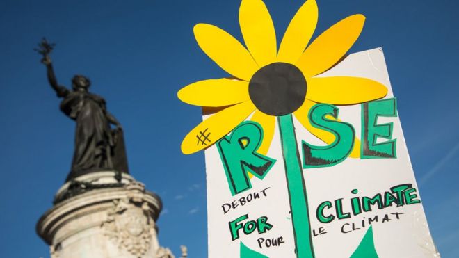 A hand-drawn sunflower on a "Rise for the Climate" poster during the "March for the climate", in Republic Square, Paris, France on 8 September 2018