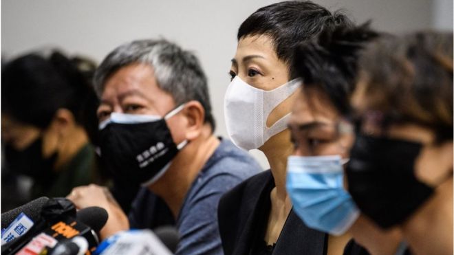 Tanya Chan (C) of the Civic Party, Jimmy Sham (2nd R) convener of pro-democracy organisation Civil Human Rights Front (CHRF) and other pro-democracy lawmakers and activists hold a press conference in a meeting room of the Legislative Council in Hong Kong on May 22, 2020.