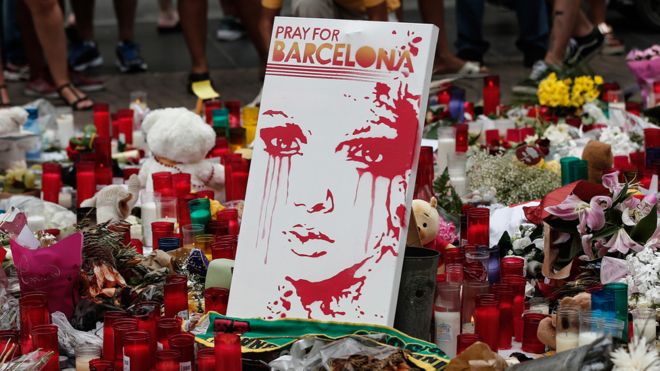 Floral tributes for victims of the Barcelona attack include a sign saying Pray for Barcelona