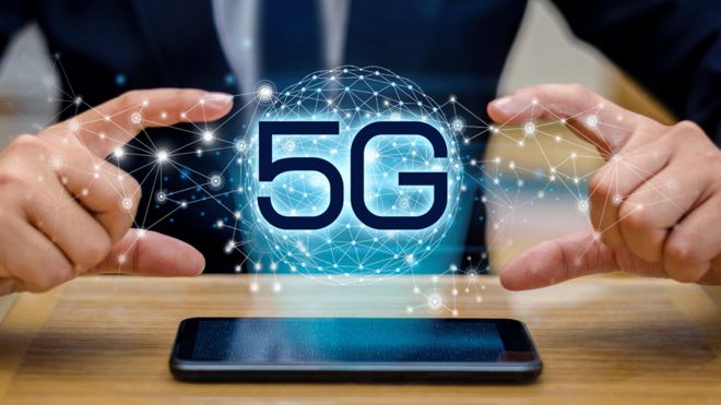 5G logo above a mobile phone