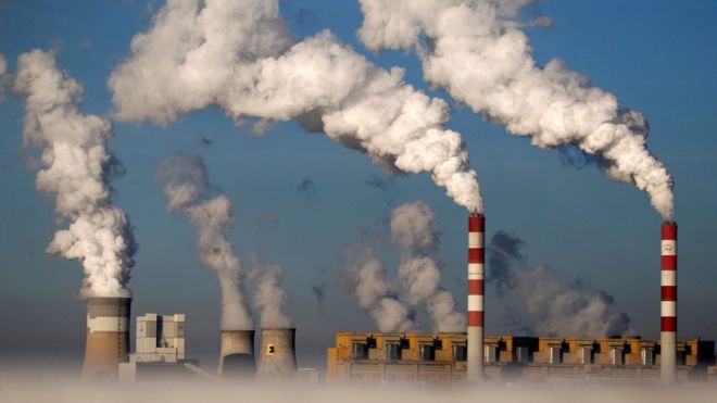 Smoke billows from chimneys at a power station in Belchatow, Poland