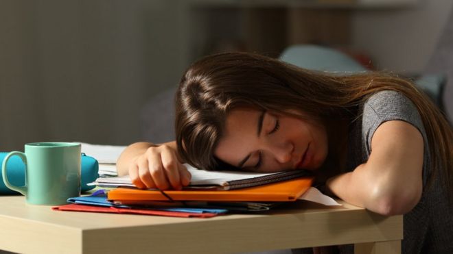 Teenage girl asleep on her homework