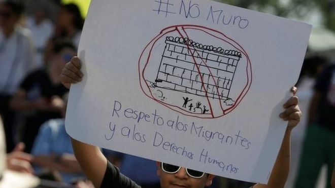 A demonstrator holds a placard reading: "No wall. Respect to immigrants and human rights" during a protest against U.S. President Donald Trump's proposed border wall and to call for unity, in Monterrey, Mexico, on 12 February