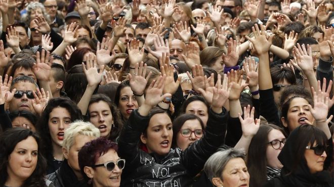 Protesters raise their arms in Pamplona on April 28, 2018, in the third day of demonstrations after five men were cleared of rape