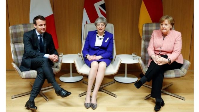 UK PM Theresa May sits with German Chancellor Angela Merkel and French President Emmanuel Macron