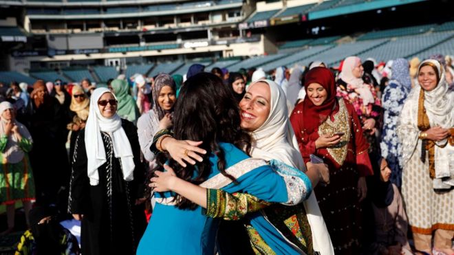 Women embrace at an Eid gathering in a stadium in Anaheim, California