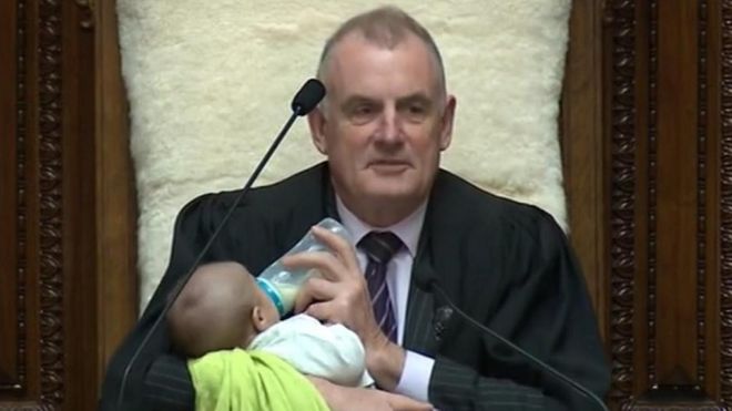 New Zealand's speaker Trevor Mallard cradles an MP's baby during a debate
