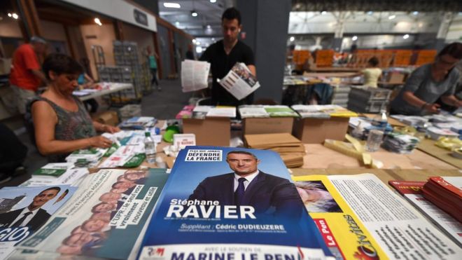 Employees prepare election leaflets for the upcoming French legislative elections on June 2, 2017 in Marseille, southern France