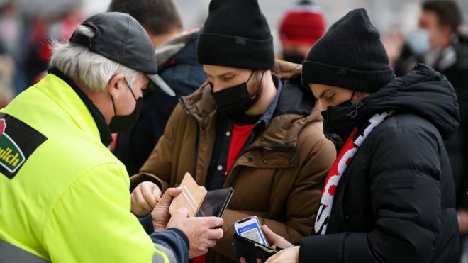 Fans arrive at the stadium and have their devices scanned as part of the 2G COVID-19 protocols prior to the Bundesliga match between Sport-Club Freiburg and Eintracht Frankfurt at SC-Stadion on November 21, 2021 in Freiburg im Breisgau, Germany.
