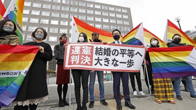 Plaintiffs" lawyers and supporters show a banner that reads "Unconstitutional decision" after a district court ruled on the legality of same-sex marriages outside Sapporo district court in Sapporo, Japan