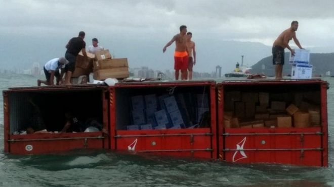 Police photo showing people looting containers from Log-In Pantanal off the coast of Santos, Sao Paulo state, Brazil