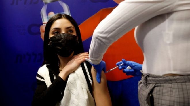 A woman receives a vaccination against the coronavirus disease in Israel