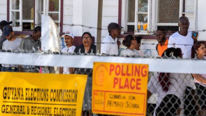 Guyanese citizens line up to vote, in Leonora, Guyana on 2 March