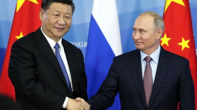 Xi and Putin shake hands in 2018