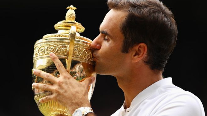 Roger Federer of Switzerland kisses the trophy as he celebrates victory after the Gentlemen"s Singles final against Marin Cilic of Croatia on day thirteen of the Wimbledon Lawn Tennis Championships at the All England Lawn Tennis and Croquet Club at Wimbledon on July 16, 2017 in London, England