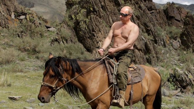 Vladimir Putin shirtless riding a horse