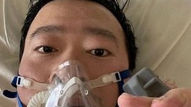 Dr Li posts a picture of himself in a gas mask from his hospital bed on Friday