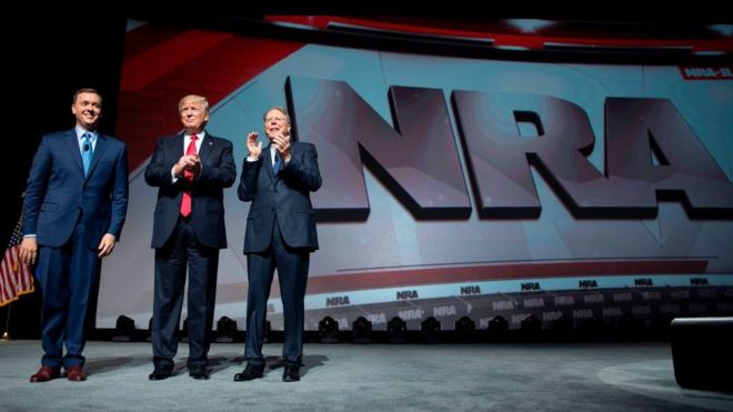 Президент США Дональд Трамп выступает с президентом Национальной стрелковой ассоциации (NRA) Уэйном Лапиером (R) и исполнительным директором NRA-ILA Крисом Коксом (слева) на Форуме лидеров NRA в Атланте, штат Джорджия, 28 апреля 2017 года.