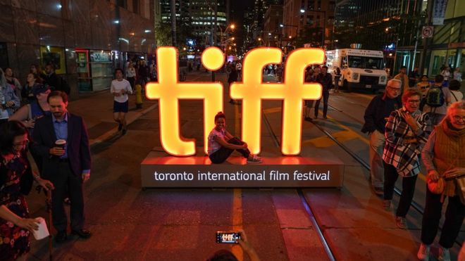 Tourist at the TIFF sign