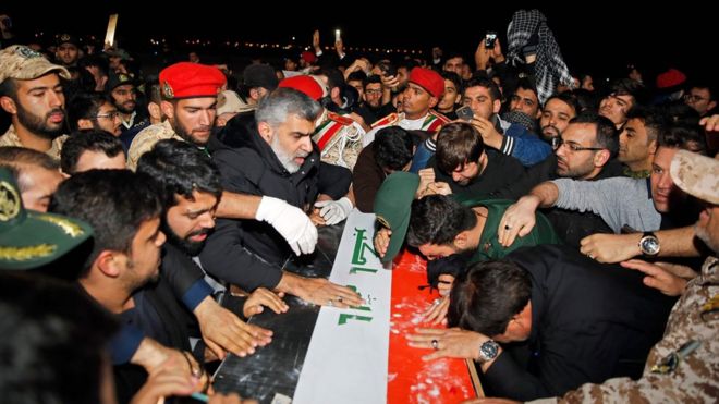 People carry the casket of Iranian commander Qasem Soleimani upon arrival at Ahvaz International Airport in Tehran on January 5, 2020. -