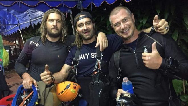 Erik Brown (l), Mikko Paasi (c) and Claus Rasmussen (r) seen holding up thumbs up after successfully completing dives that saw the rescue of all 12 boys and their football coach