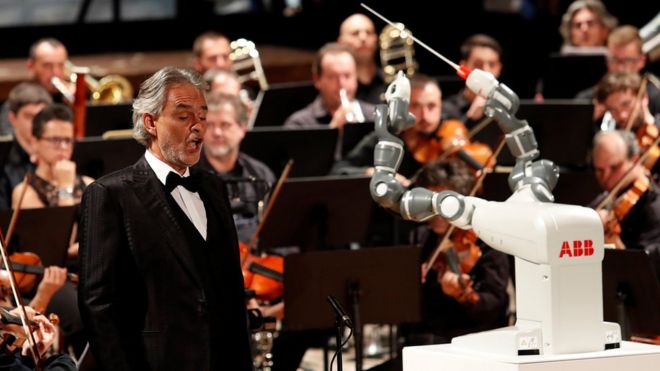 The robot YuMi conducts the Lucca Philharmonic Orchestra with Andrea Bocelli in Pisa.