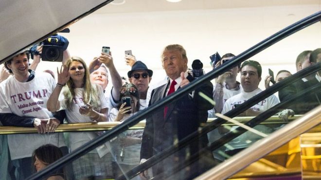 Дональд Трамп входит через золотой эскалатор
