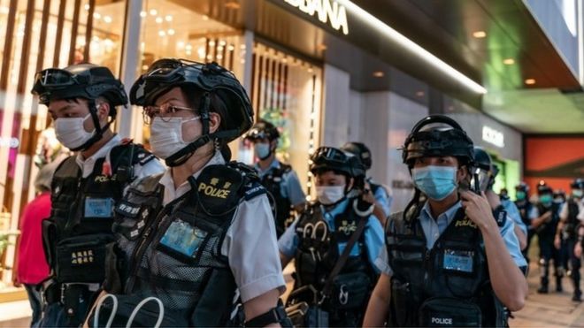 Riot police wearing protective masks patrol during a demonstration outside a shopping mall in Hong Kong
