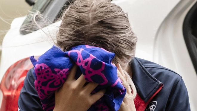 The woman covered her face as she arrived to hear the verdict