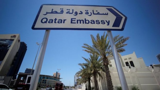 A sign indicating a route to Qatar embassy is seen in Manama, Bahrain, 5 June 2017.